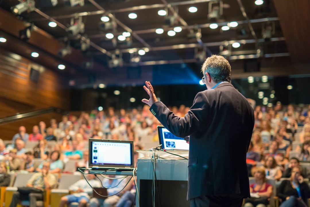 Public Speaker Giving Talk at Business Event.